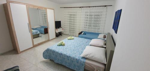 a bedroom with a blue bed and a mirror at Apartment Noa in Crikvenica