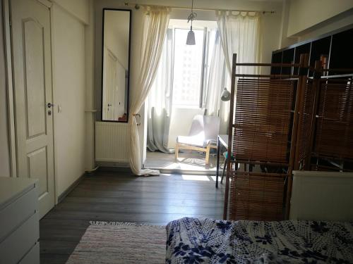 a living room with a bed and a window at Old Town Studio in Bucharest