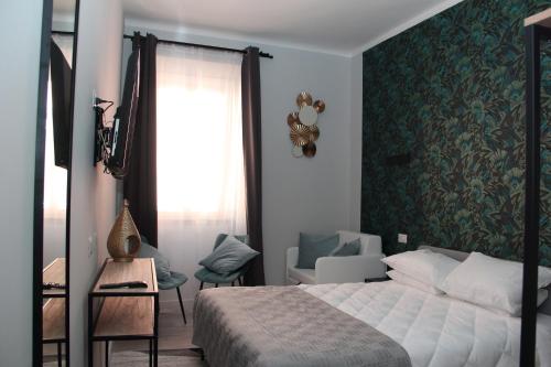 a bedroom with a bed and a green wall at Vite 99 spanish steps room in Rome
