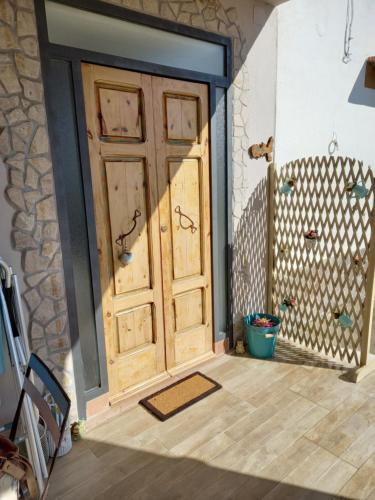 an entrance to a room with a wooden door at Nido Gagà in Capoliveri
