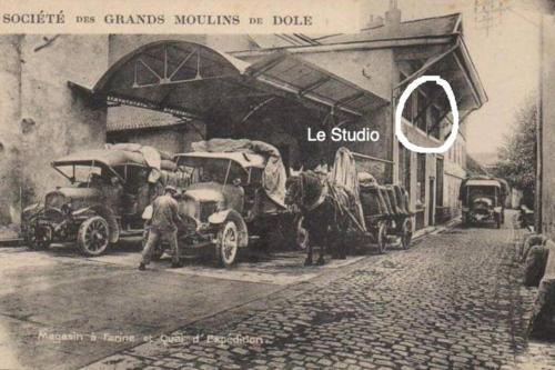 an old photo of cars parked in front of a building at Studio au Moulin " Design Noir " Vue Unique in Dole