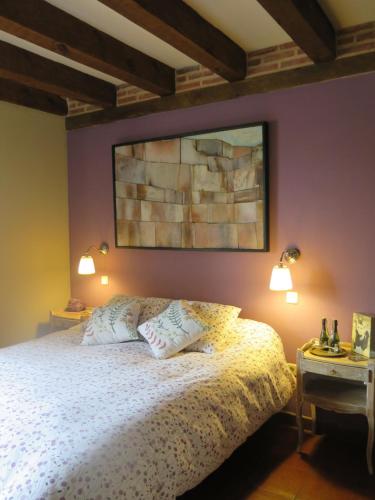 a bedroom with a bed with two pillows on it at La Casona de Requijada a 6km de Pedraza con Piscina in Requijada