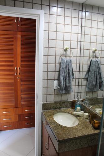 a bathroom with a sink and a mirror at Porto Real Resort - Apto 3 Suites Vista para o Mar in Mangaratiba