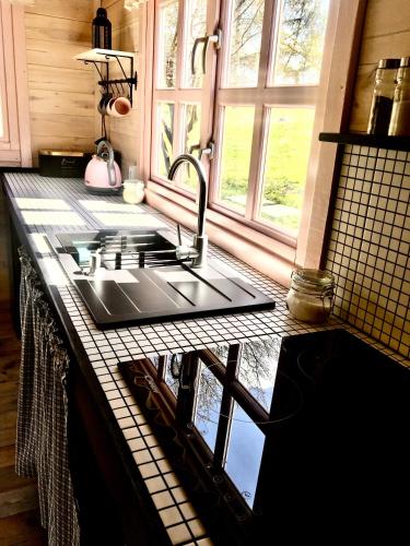 a kitchen with a sink and a counter top at 83 Bredynki in Biskupiec