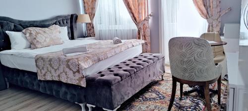 a bedroom with a bed and a chair and a desk at La Mer Boutique Hotel & Guesthouse in Istanbul