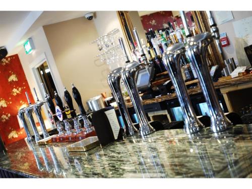 a bar with several wine glasses on a counter at Guildhall Tavern Hotel & Restaurant in Denbigh