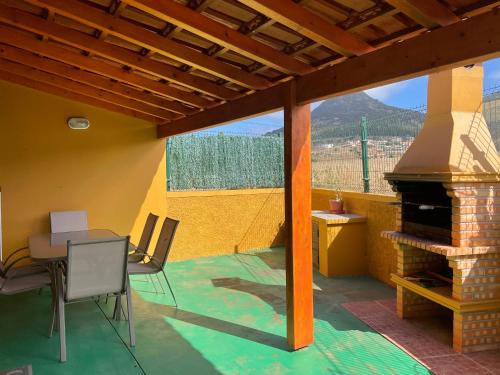 a patio with a table and a fireplace at Cantinho Solpraia in Porto Santo