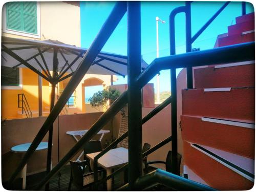 a view of a balcony with a table and chairs at Supertubos Beach Hostel in Peniche