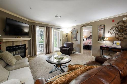 a living room with a couch and a table at Luxury Condos at Thousand Hills - Heart of Branson - Beautifully remodeled - Spacious and Affordable in Branson