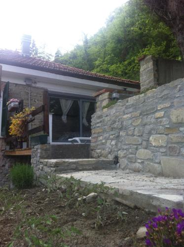 a stone house with a stone wall and a window at Villa Gioia in Acqui Terme
