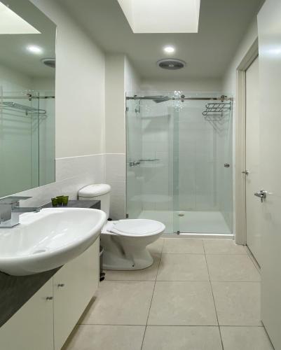 a bathroom with a sink and a toilet and a shower at Shells Apartments in Sorrento