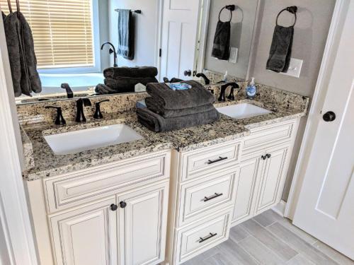 a bathroom with two sinks and two mirrors at Spacious deluxe house for you, your family and friends in Charlotte