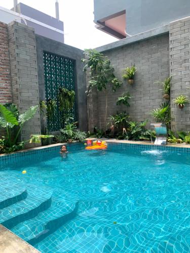 a swimming pool with a person in the water at The J Break Boutique in Kampot