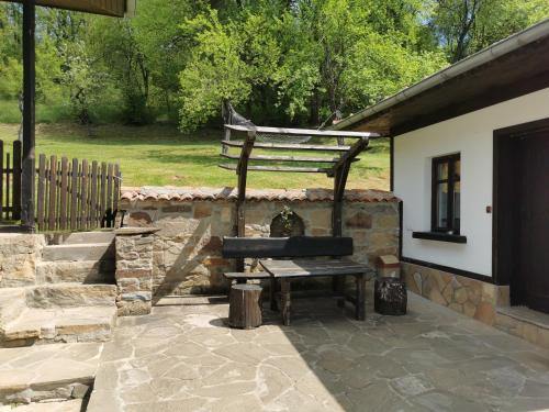 a bench sitting on a patio next to a building at АРНАТА КЪЩА in Yakovtsi