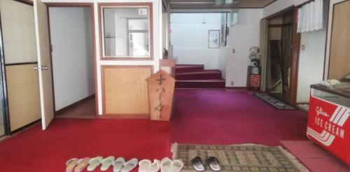 a hallway with a bunch of shoes on the floor at Suijin Hotel - Vacation STAY 23125v in Chichibu