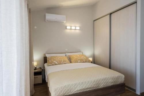 - une chambre avec un grand lit dans l'établissement Apartmani Savin, à Brodarica