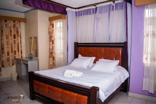 ein Bett mit zwei weißen Handtüchern darauf in einem Schlafzimmer in der Unterkunft Tommy's Airport Lounge in Nairobi