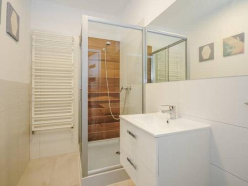 a bathroom with a shower and a sink and a mirror at Willa u Tośka in Kołobrzeg