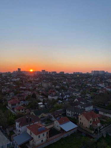 a view of a city with the sunset in the background at Omega 6 in Odesa