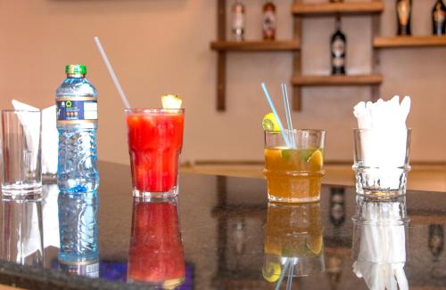 a group of three different colored drinks on a counter at Hotel Comster Mtwapa in Mtwapa