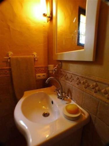 a bathroom with a white sink and a mirror at Villa Paraiso. Villas Ahumada in Tarifa