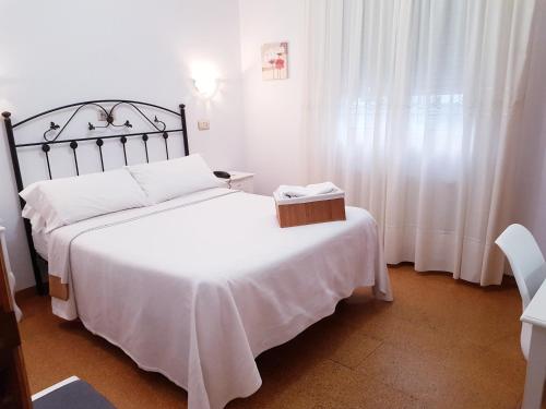 a hotel room with a bed and a dresser at Carabela La Pinta in Baiona