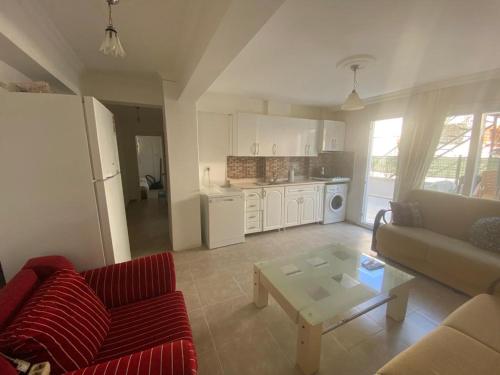 a living room with a couch and a coffee table at DİDİM Ege Apart in Didim