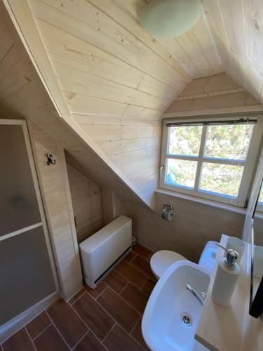 a small bathroom with a sink and a toilet at Chata Leštiny in Leštiny