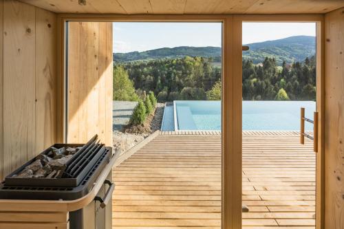 a wooden house with a view of a swimming pool at steiRerBLiCke - Kellerstöckl Steinreib in Steinreib