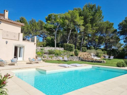 a swimming pool in front of a house at Cosy en Provence - Piscine chauffée in Pernes-les-Fontaines