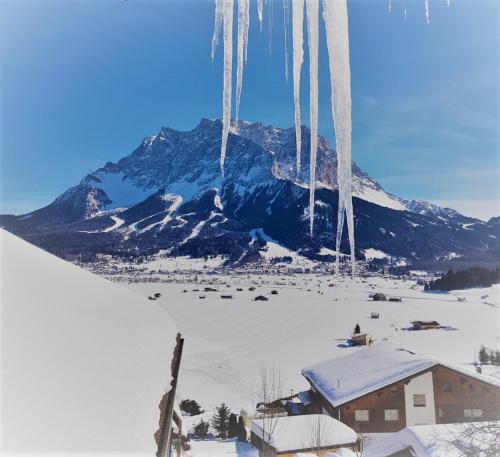 a ski lift in front of a snow covered mountain at Haus Montana in Lermoos