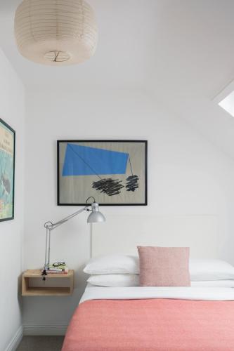 a bedroom with a bed with a pink blanket at The Stop in Galway