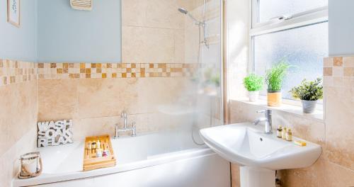 a bathroom with a sink and a toilet and a tub at The Bishophill Gathering York - Sleeps Up To 12 in York