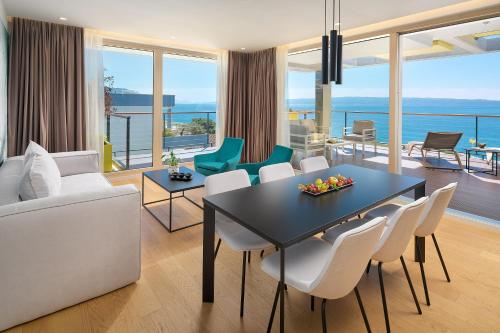 a living room with a table and chairs at Amphora's Garden in Split