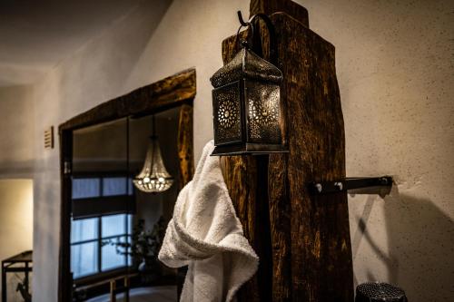 a bathroom with a towel and a light on a wall at ZaVélo Suite in Bernkastel-Kues