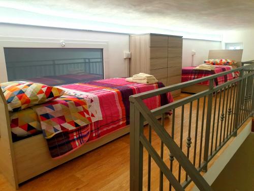 a bedroom with two beds and a balcony at Apartment Mary in Terracina