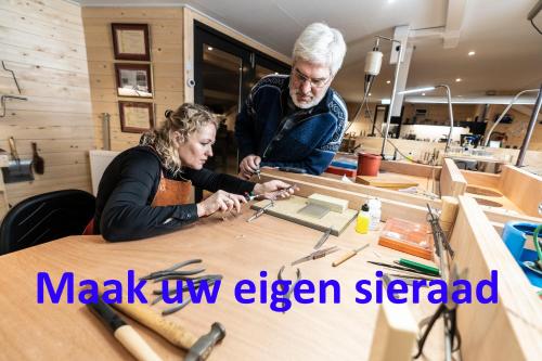 a man and a woman working on a wooden table at B&B De Oldambtster in Beerta