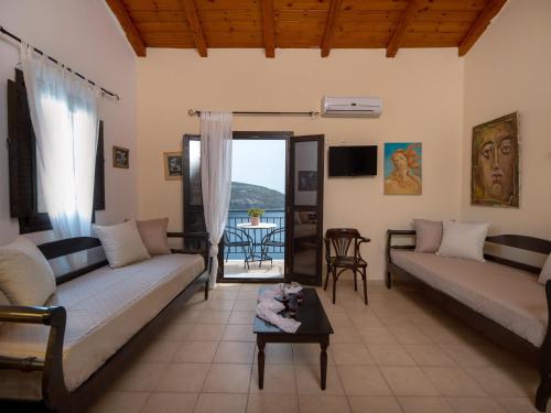 a living room with two couches and a table at Selana View in Karavostasion