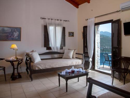a living room with a bed and a balcony at Selana View in Karavostasion