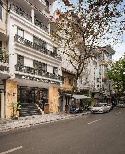 a white car parked in front of a building at Romantique Hotel De Hanoi in Hanoi