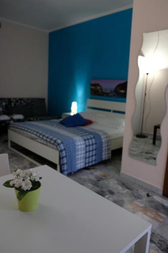 a bedroom with a bed and a blue wall at Bed & Breakfast Il Golfo in Naples
