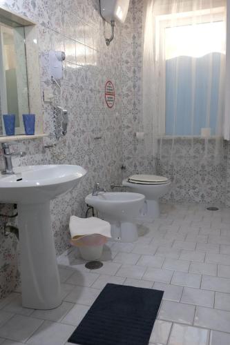 a bathroom with a sink and a toilet at Bed & Breakfast Il Golfo in Naples