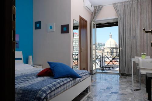 a bedroom with a bed and a view of a building at Bed & Breakfast Il Golfo in Naples