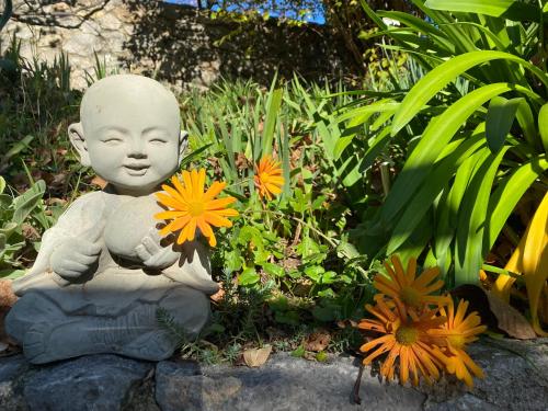 a statue of a little boy holding a bunch of flowers at Mas Giro in Le Bar-sur-Loup
