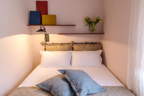a bed with two pillows on it in a room at Ex Convento Santa Croce-Country resort in SantʼAnatolia di Narco