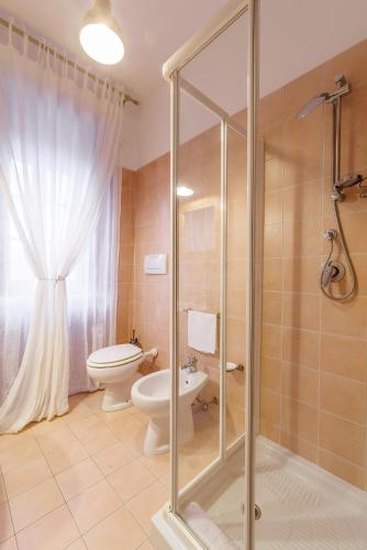 a bathroom with a toilet and a glass shower at Ex Convento Santa Croce-Country resort in SantʼAnatolia di Narco