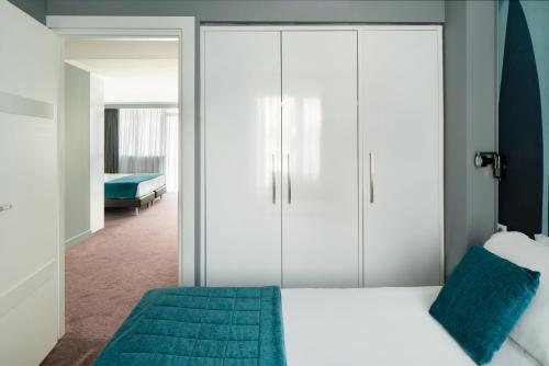 a bedroom with white cabinets and a bed at Juliana Hotel Cannes in Cannes