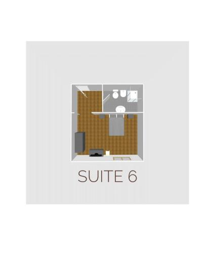 a room with a sofa and a chair with the text suite at HH Hermoso Housing VALENZA in Valenza