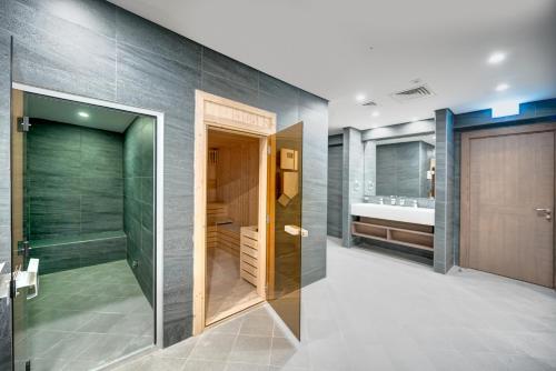 a bathroom with a shower and a sink at ABAR HOTEL APARTMENTS DIP-1 in Dubai