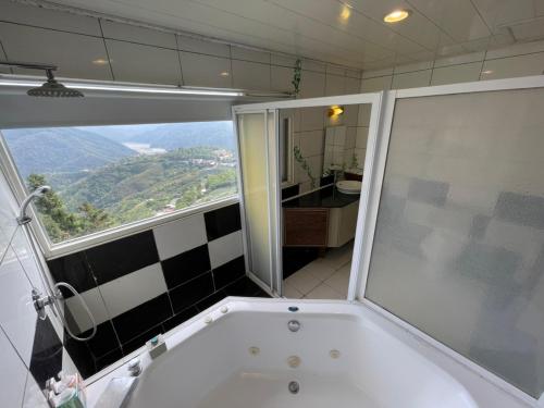 a bath tub in a bathroom with a window at Emmanuel Farm House in Renai